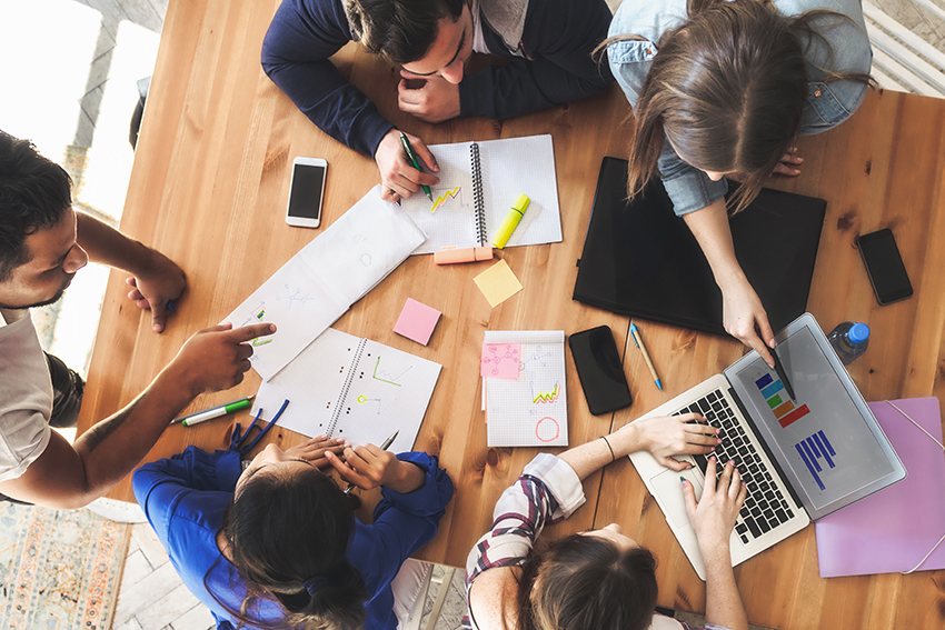 Students seen overhead working together at a desk