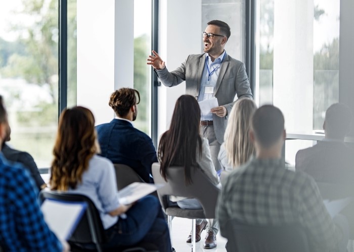 Man presenting in front of a group of individuals