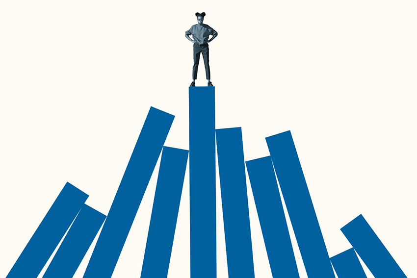Woman on top of 10 blue vertical bars, looking down on them from on high