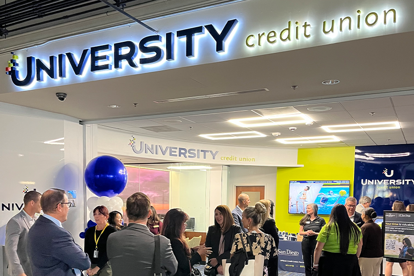University Credit Union location shown with a group of clients and guests